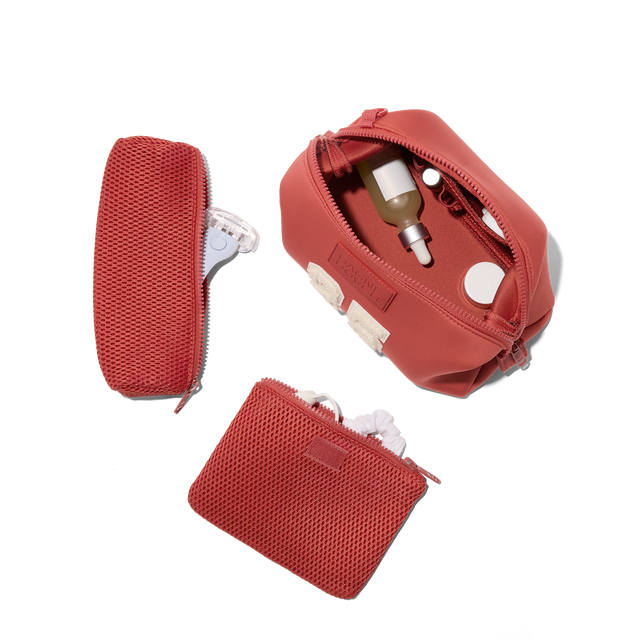 Dagne Dover Large Hunter Toiletry Bag in a poppy, vintage wash red. unzipped and seen from above with the removable air mesh pouch alongside it. hover
