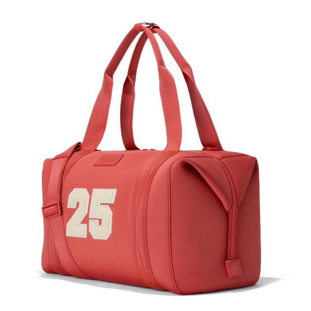 Dagne Dover large Landon Carryall in a poppy, vintage wash red, seen from an angle.
