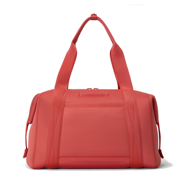 Dagne Dover large Landon Carryall in a poppy, vintage wash red, seen from the back displaying an exterior phone pocket.
