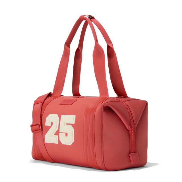 Dagne Dover medium Landon Carryall in a poppy, vintage wash red, seen from an angle.
