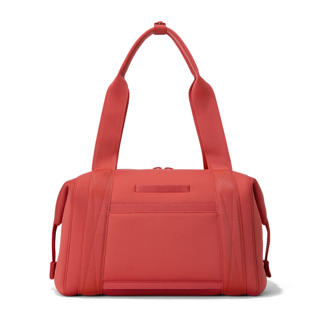 Dagne Dover medium Landon Carryall in a poppy, vintage wash red, seen from the back displaying an exterior phone pocket.
