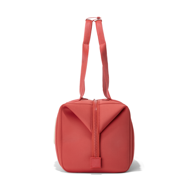 Dagne Dover medium Landon Carryall in a poppy, vintage wash red, seen from the side.
