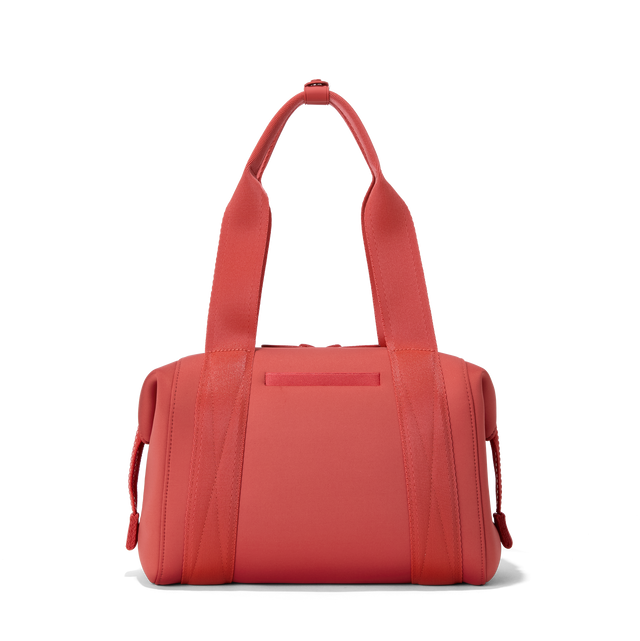 Dagne Dover small Landon Carryall in a poppy, vintage wash red, seen from the back displaying an exterior phone pocket.
