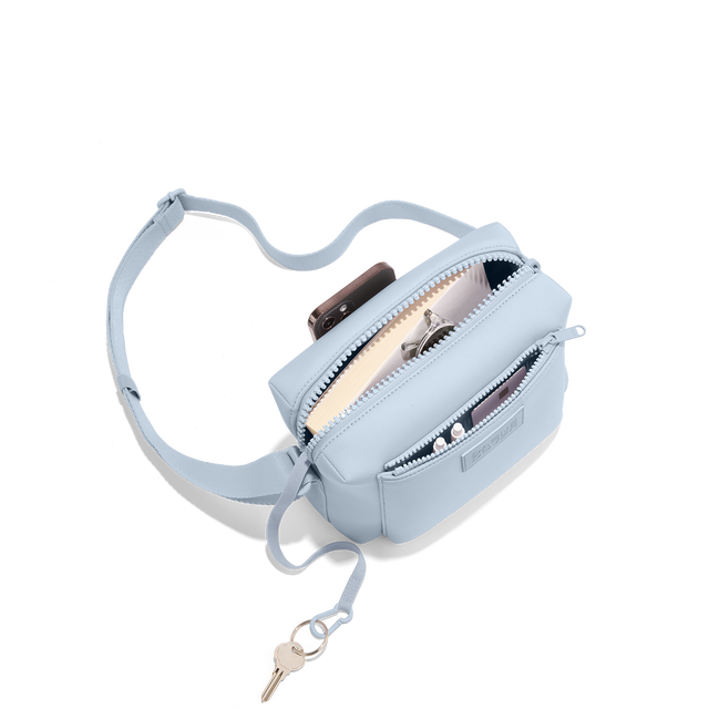 Dagne Dover Micah Crossbody in an airy, lighter sky blue seen from above, showing the interior air mesh pocket. hover
