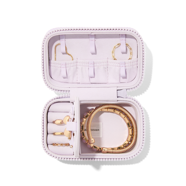 Dagne Dover Small Frankie Jewelry Case in a custom washed lilac and cream floral print, seen open from above with jewelry inside and the interior compartment open.