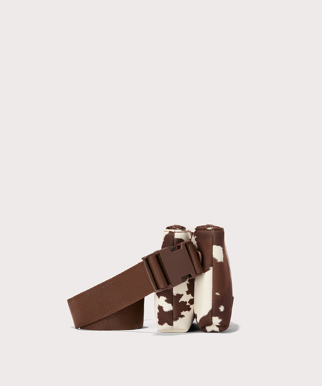 Dagne Dover Bennie Sling in a cow print as seen from the side view.