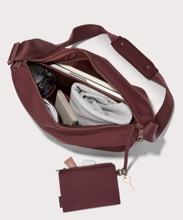 Large Shoulder bag in a deep brown with purple undertones reminiscent of maroon seen from the top down view showing interior mesh pouch.
