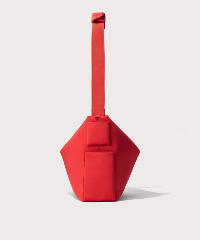 Large Shoulder bag in a fiery, saturated red leaning toward orange seen from the side view showing phone pocket.
