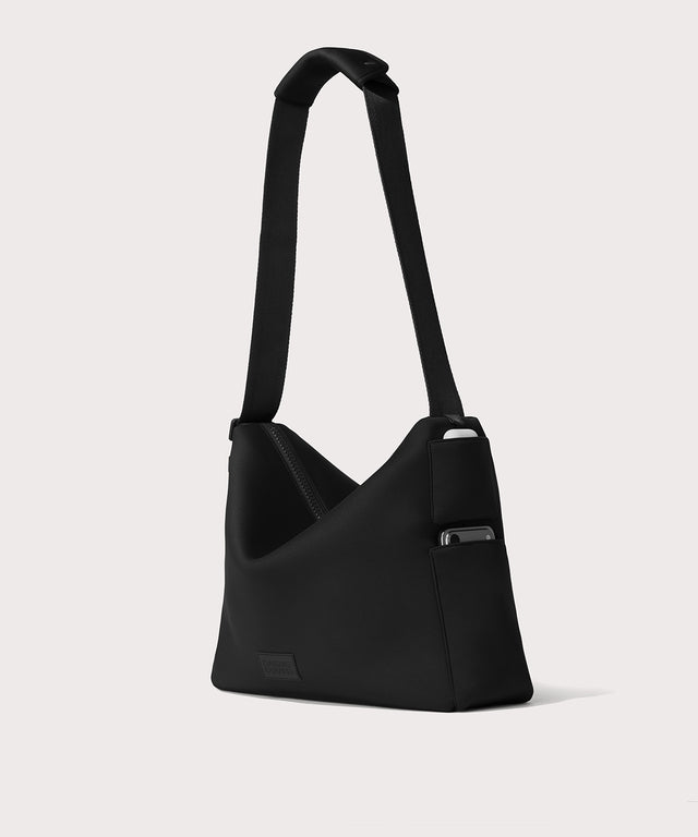 Large Shoulder bag in a black seen from the angle view showing phone pocket.
