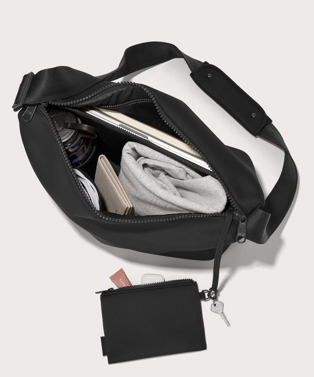 Large Shoulder bag in a black seen from the top down view showing interior mesh pouch.
