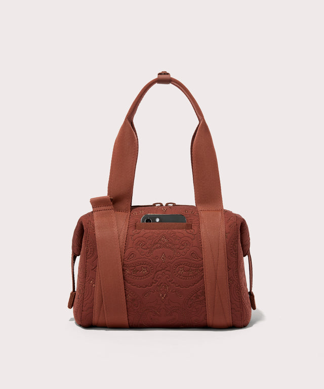 Dagne Dover Small Landon Carryall in a rich, warm brown with an embroidered paisley print seen from the back, displaying the phone pocket.
