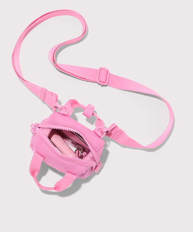 Dagne Dover Micro Landon Crossbody in a true bubble gum pink unzipped, seen from above showcasing the interior.