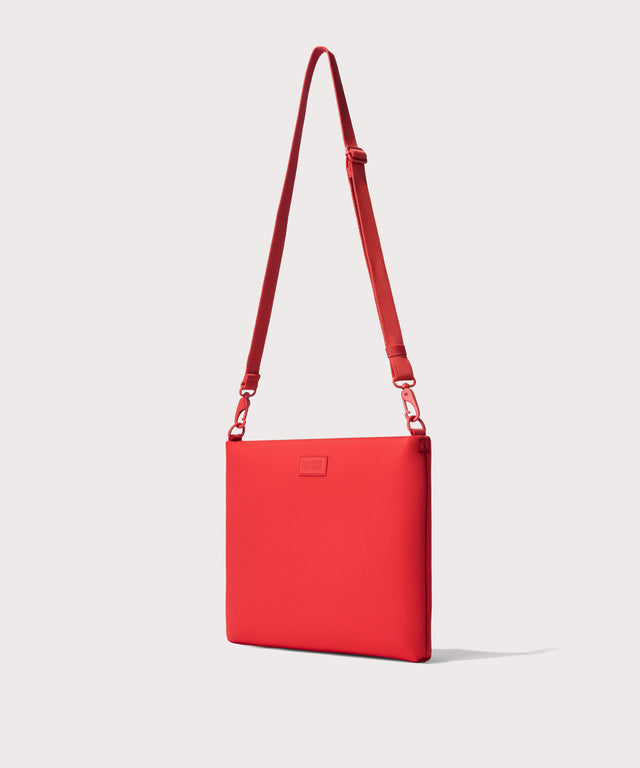 14 inch laptop shoulder bag in a fiery, saturated red leaning toward orange seen from the angle view.