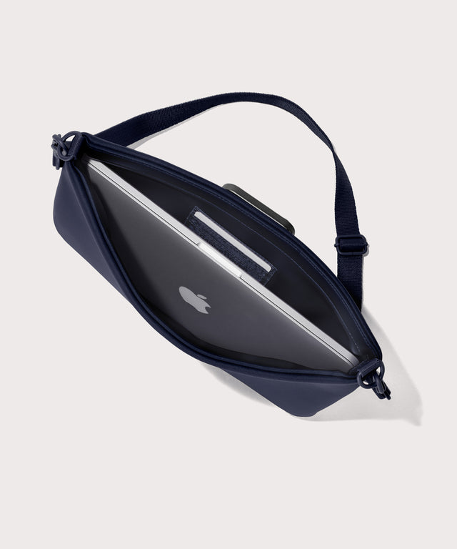 14 inch laptop shoulder bag in a navy blue  seen from the top down view showing interior.