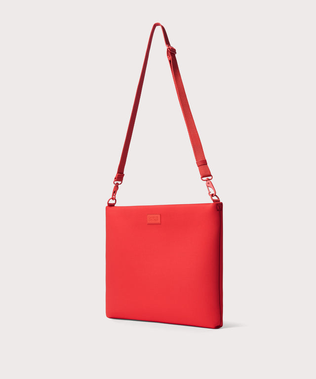 16 inch laptop shoulder bag in a fiery, saturated red leaning toward orange seen from the angle view.