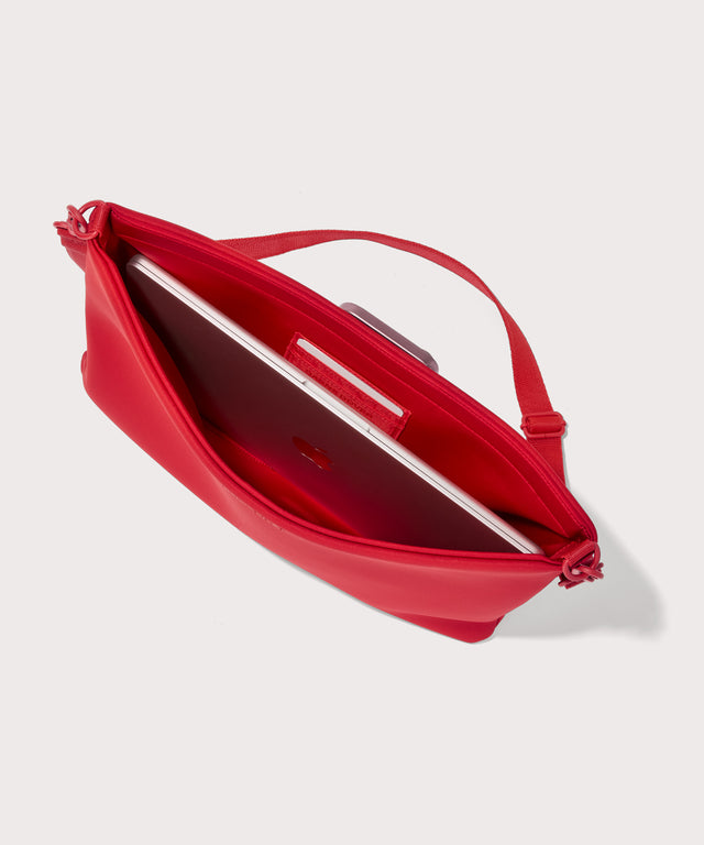 16 inch laptop shoulder  bag in a fiery, saturated red leaning toward orange seen from the top down view showing interior.
