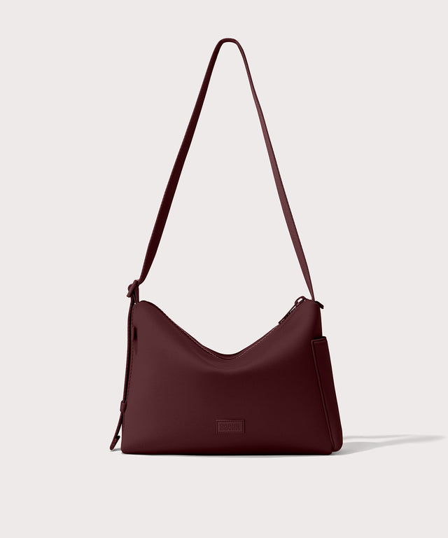 Shoulder bag in a deep brown with purple undertones reminiscent of maroon seen from the front view. 
