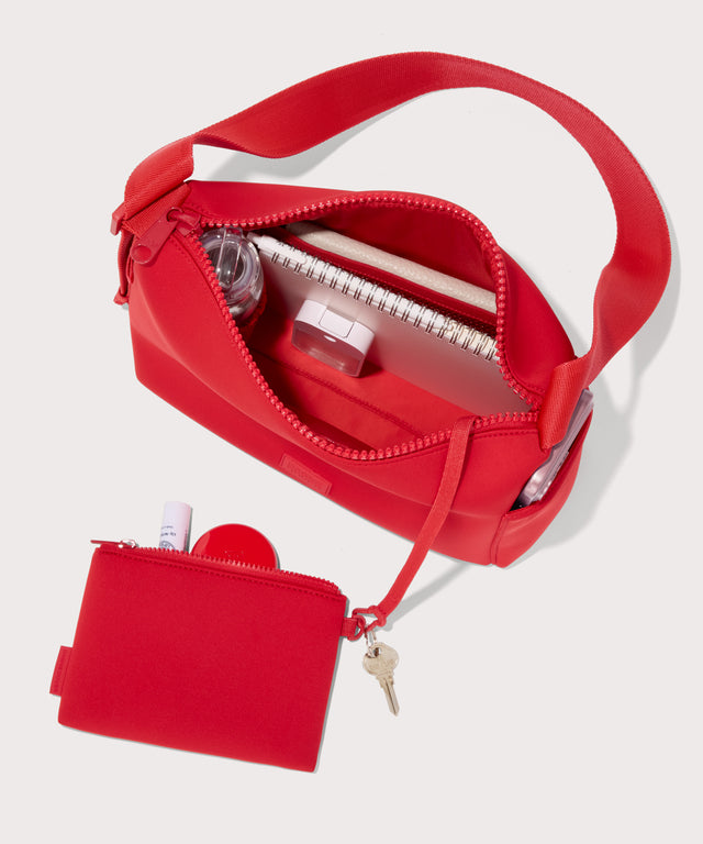 Shoulder bag in a fiery, saturated red leaning toward orange seen from the top down view showing interior mesh pouch.