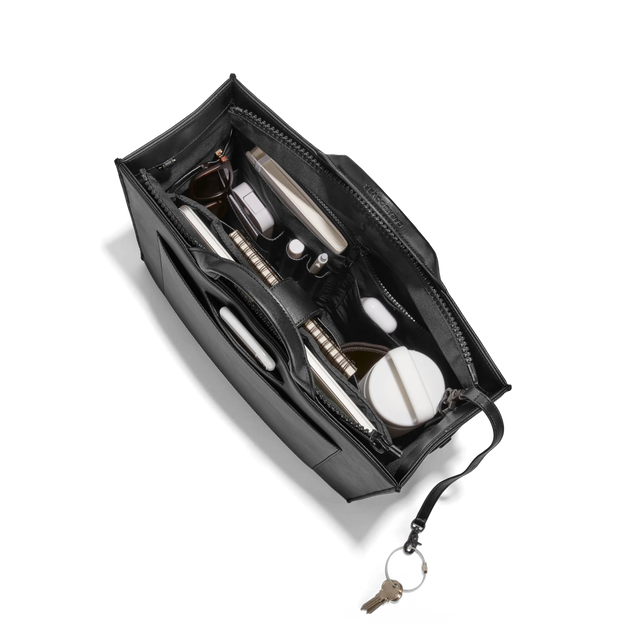 Dagne Dover medium vegan Daily Tote in black from above, revealing the interior zipper, interior slip pockets, and padded laptop sleeve.