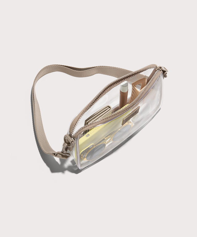 Clear waist bag with beige strap on a white background—stadium compliant. 