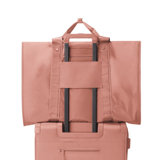 Back view of Capri garment bag in warm dust on luggage handle