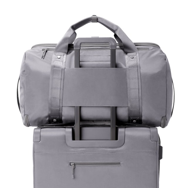 Back view of Monaco garment duffle in ash on luggage handle