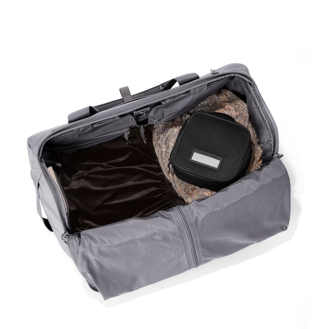 Top down of Monaco garment duffle in ash with packing cube on the right side.