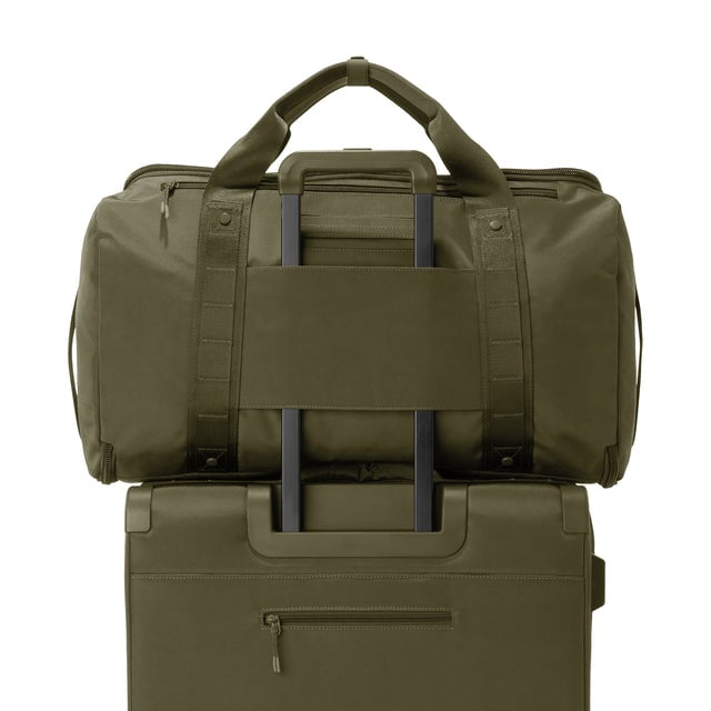 Back view of Monaco garment duffle in dark moss on luggage handle