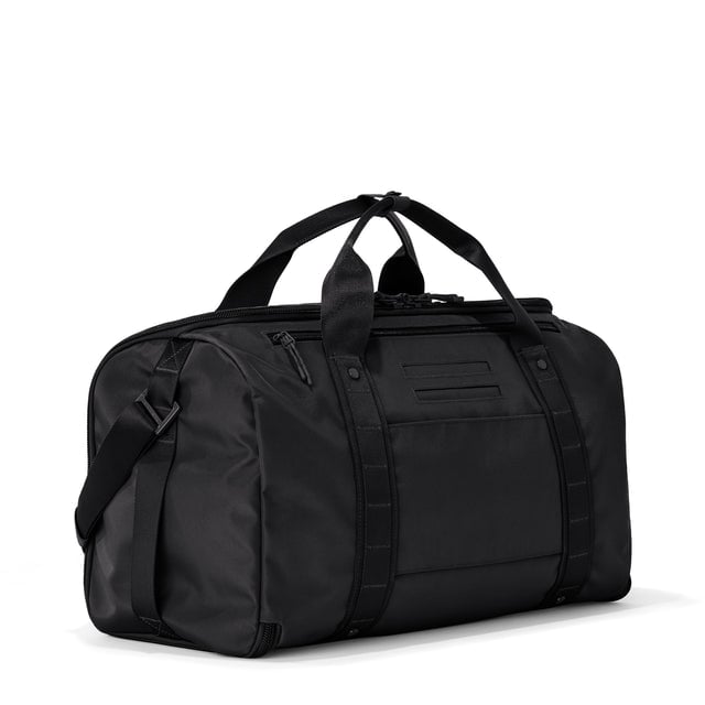 3/4 back view of Monaco garment duffle in onyx showing back zippered tech pocket and phone/passport pockets