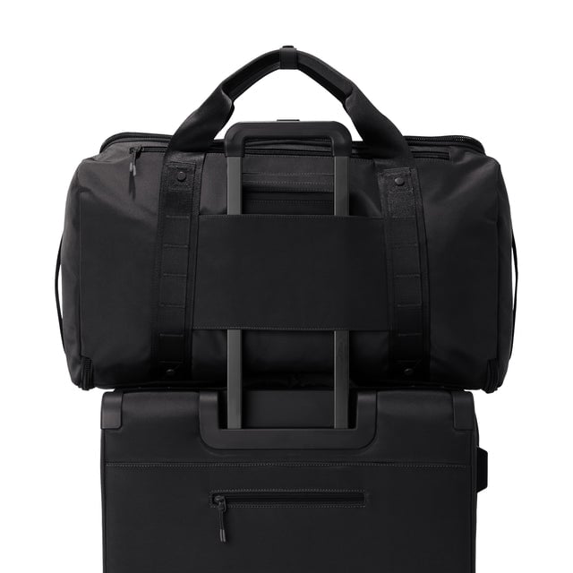 Back view of Monaco garment duffle in onyx on luggage handle