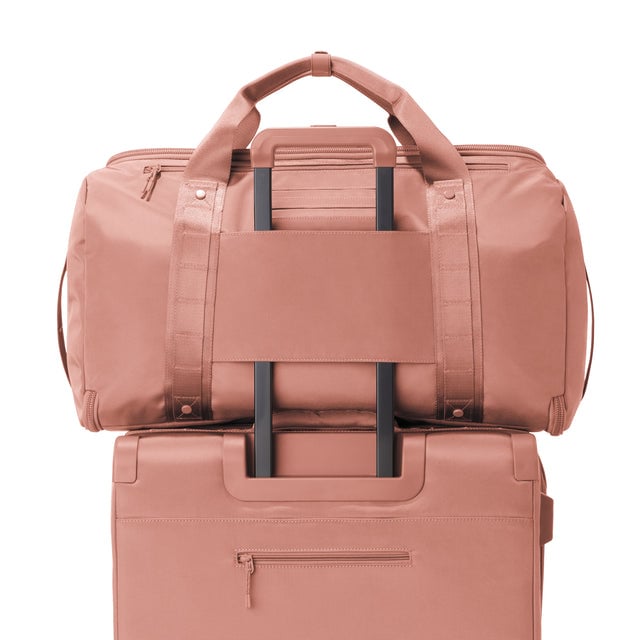 Back view of Monaco garment duffle in warm dust on luggage handle