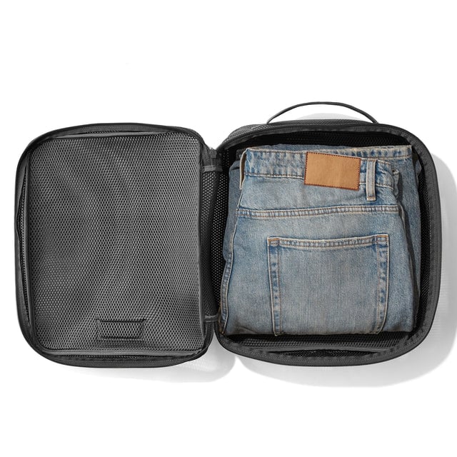 Large Roma packing cube in carbon black open with jeans inside