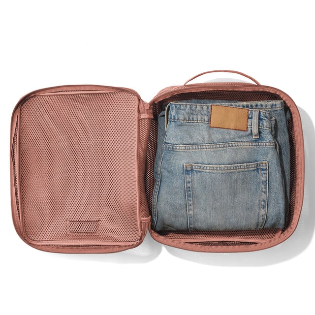 Large Roma packing cube in warm dust open with jeans inside