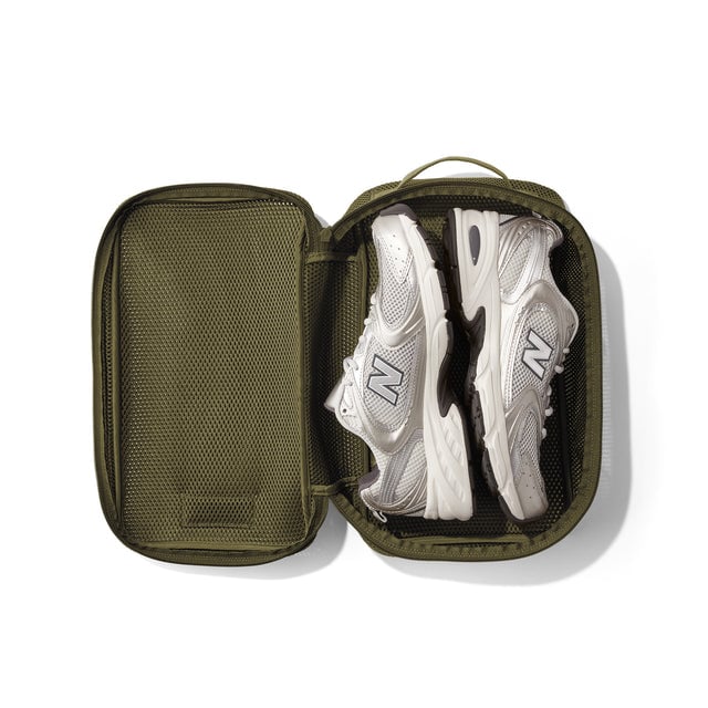 Medium Roma packing cube in dark moss open with sneakers inside. 