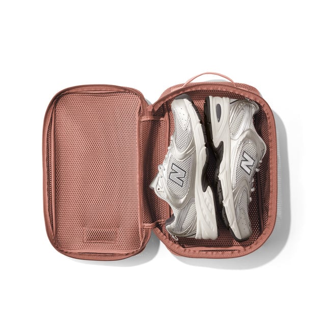 Medium Roma packing cube in warm dust open with sneakers inside. 