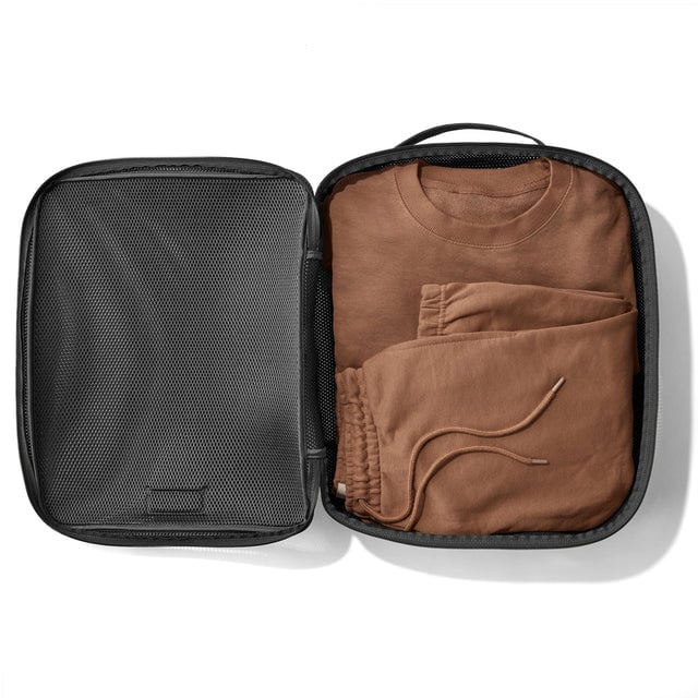 Extra Large Roma packing cube in carbon grey open with sweatshirt and sweatpants inside.