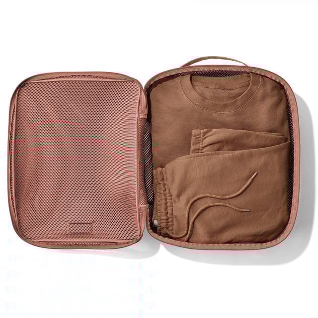Extra Large Roma packing cube in warm dust open with sweatshirt and sweatpants inside. 