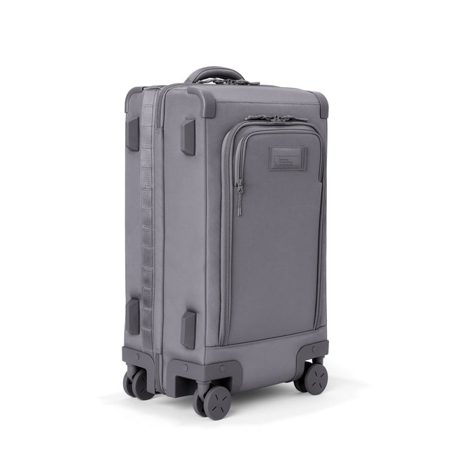3/4 front view of Seattle carry-on rolling luggage 23.5” in ash showing side luggage feet