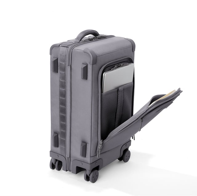 ¾ front view of Seattle carry-on rolling luggage 23.5”  in ash with front flap opened. Caption: Interior slip pocket fits most 16