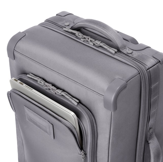 Detail shot of front zipper pocket in ash. Caption: Front pocket fits most 13” laptops