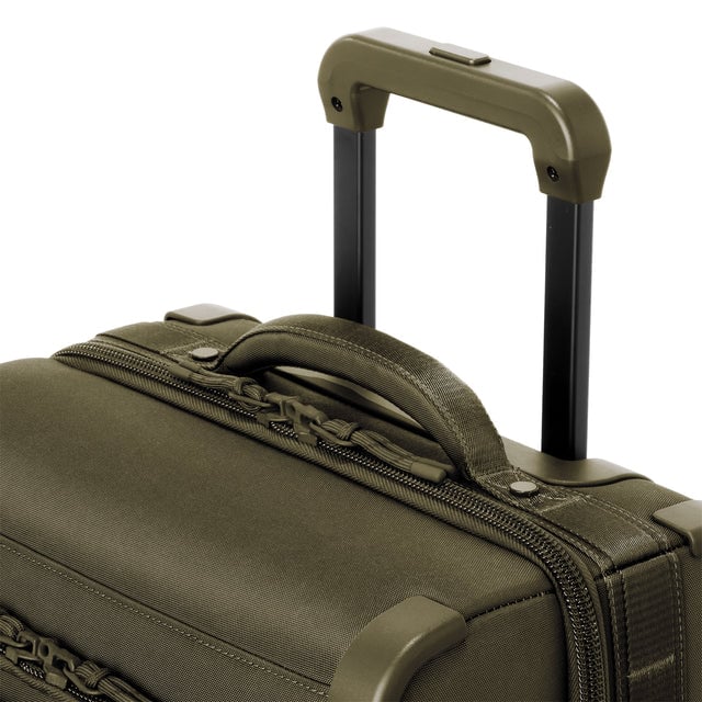 Detail shot of Seattle carry-on rolling luggage 23.5” in dark moss extended luggage handle and puffy handle