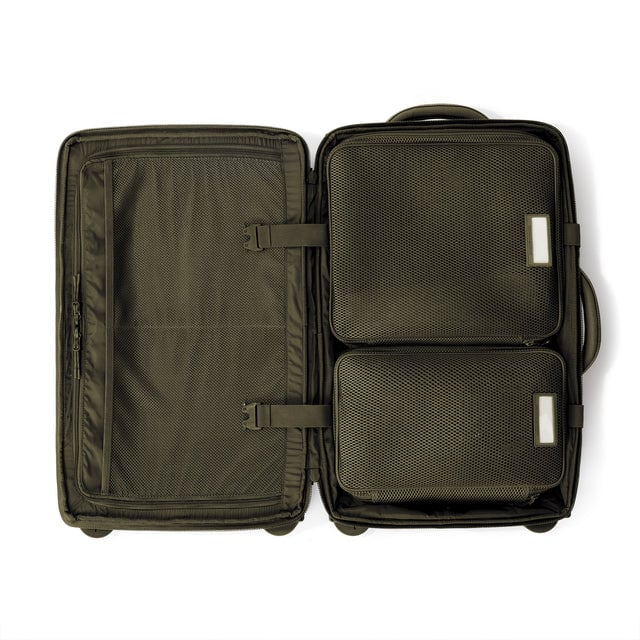 Top down of Seattle carry-on rolling luggage 23.5” in dark moss with interior divider zipped and packing cubes packed into the right side. Hover