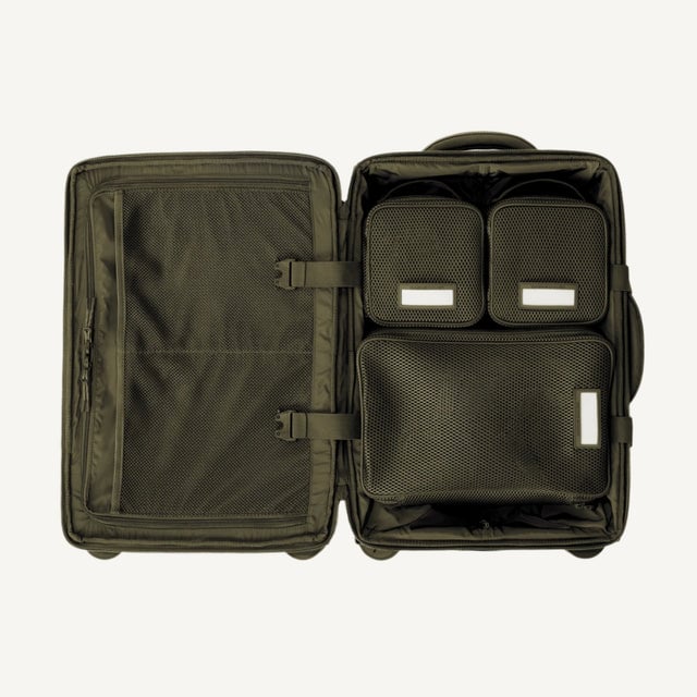 Top down of Seattle carry-on rolling luggage 20.5” in dark moss with interior divider zipped and packing cubes packed into the right side. Hover