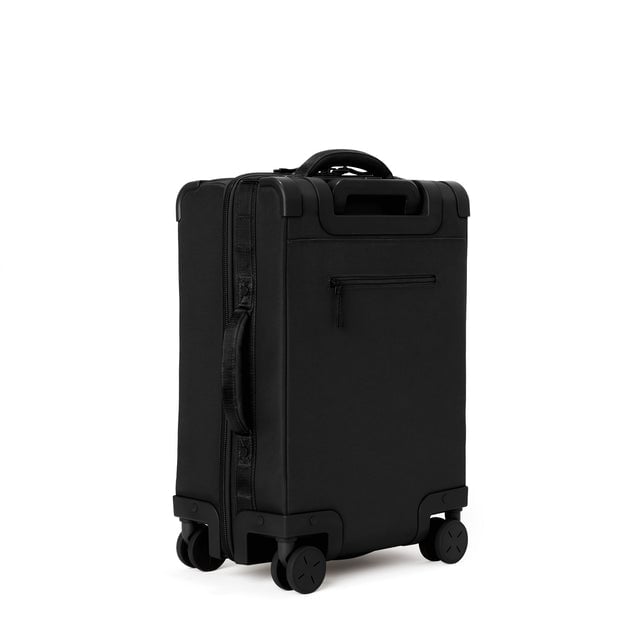 3/4 back view of Seattle carry-on rolling luggage 20.5” in onyx showing side handle and back zippered phone/passport pocket