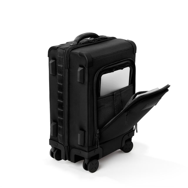 ¾ front view of Seattle carry-on rolling luggage 20.5” in onyx with front flap opened. Caption: Interior slip pocket fits most 13