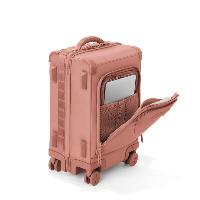 ¾ front view of Seattle carry-on rolling luggage 20.5” in warm dust with front flap opened. Caption: Interior slip pocket fits most 13