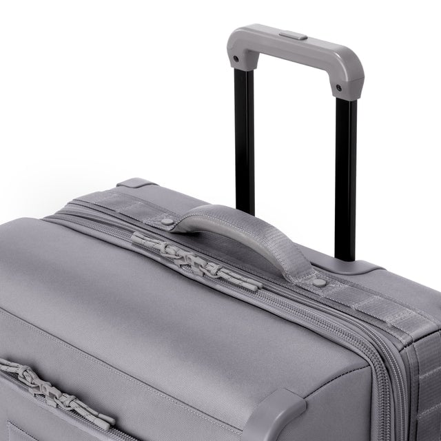 Detail shot of Sydney checked rolling luggage 25” in ash grey extended luggage handle and puffy handle