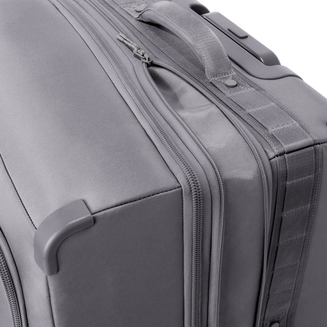 Detail shot of Sydney checked rolling luggage 25” in ash grey expandable zipper feature