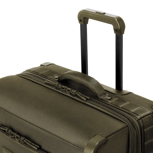 Detail shot of Sydney checked rolling luggage 25” in dark moss extended luggage handle and puffy handle