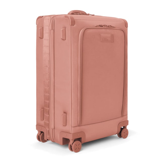 3/4 front view of Sydney checked rolling luggage 28.5” in warm dust showing side luggage feet